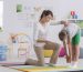Child standing forward bend while exercising with physiotherapist